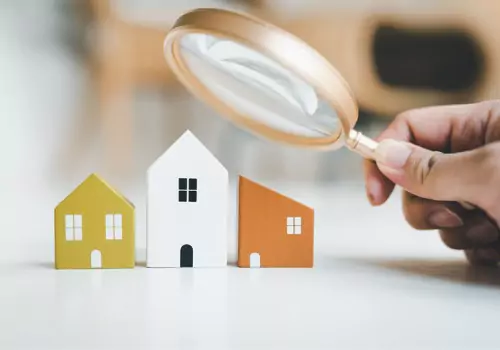 magnifying-glass-and-house-model-house-selection-real-estate-concept